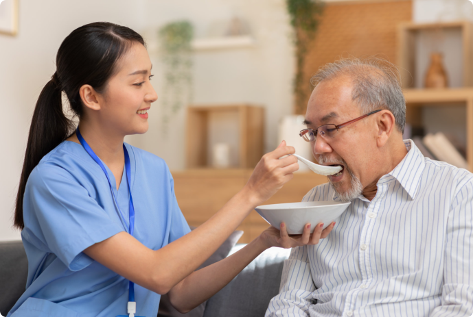 Caretaker feeding a person