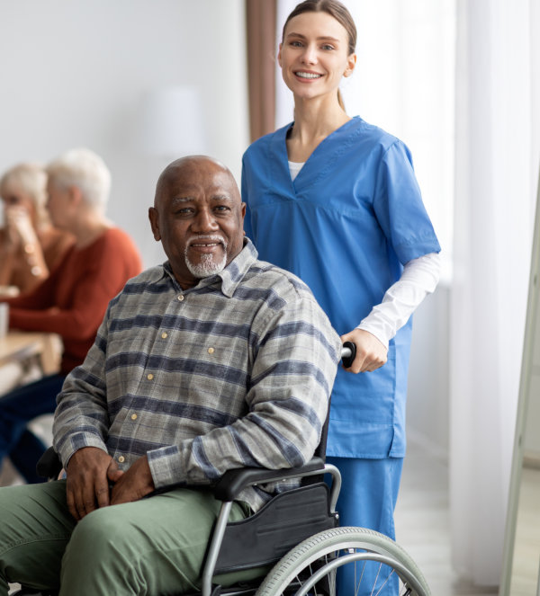 Caretaker helping an elderly man