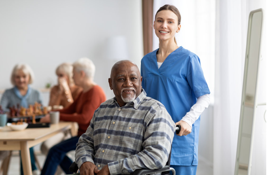 Caretaker helping an elderly man